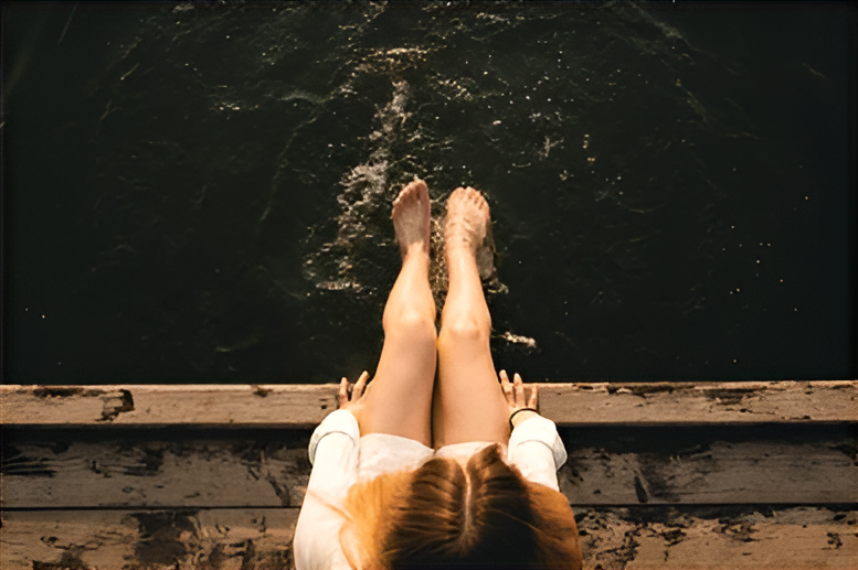 Dangling my feet over a riverside bench, looking at the tranquil Vltava River.