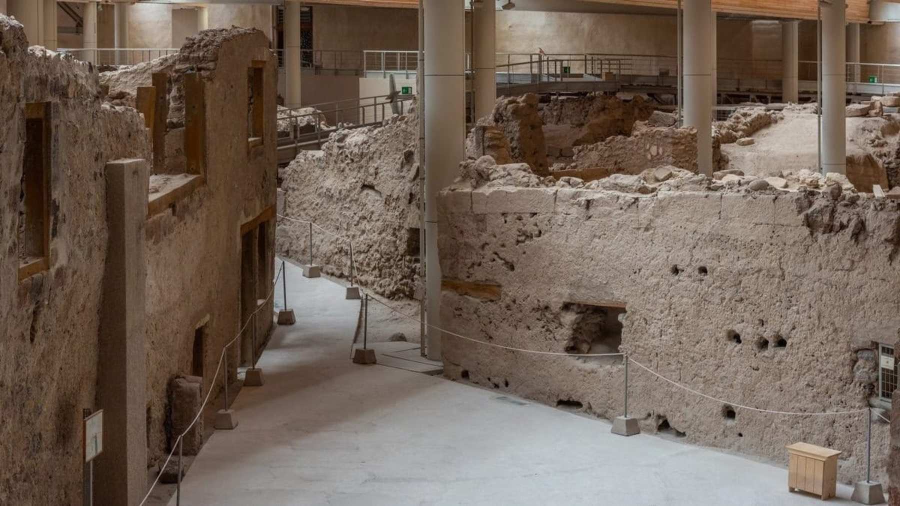 The ruins of Akrotiri in Santorini, with well-preserved Minoan frescoes and ancient stone pathways.