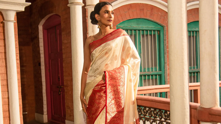 A model showcasing an elegant handcrafted Banarasi silk saree, representing India's commitment to sustainable fashion.